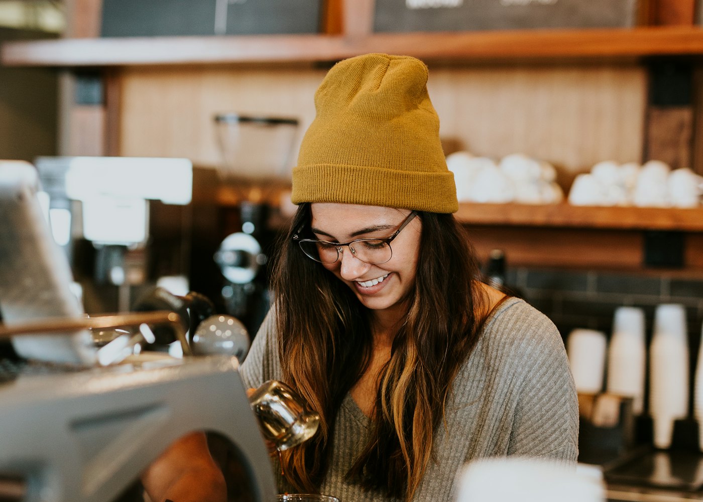 Cafe owner smiling behind her counter