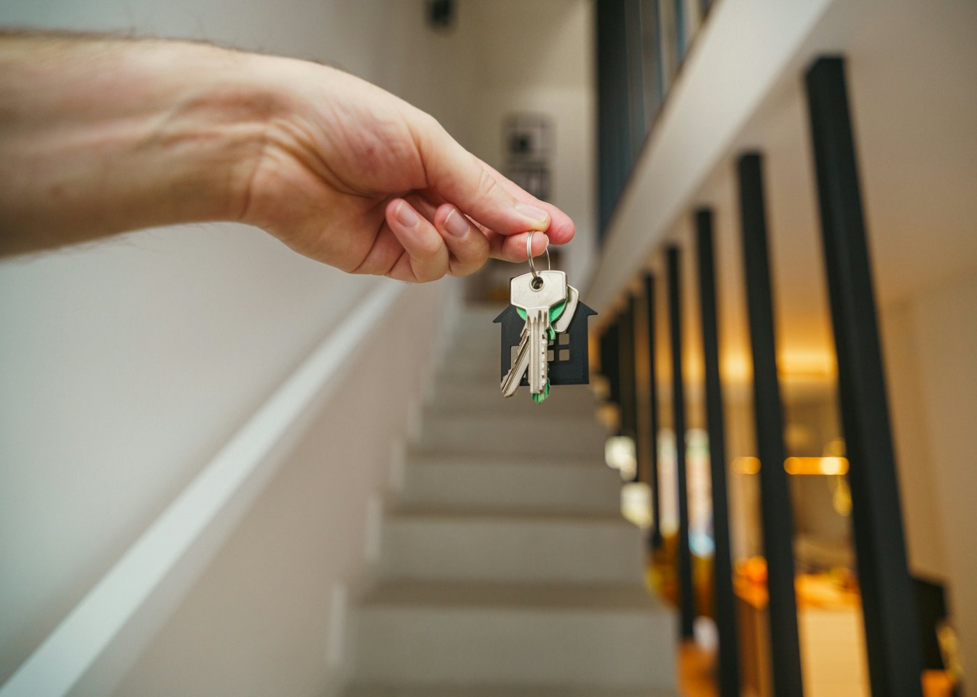 Hand holding the keys to a new home in a doorway