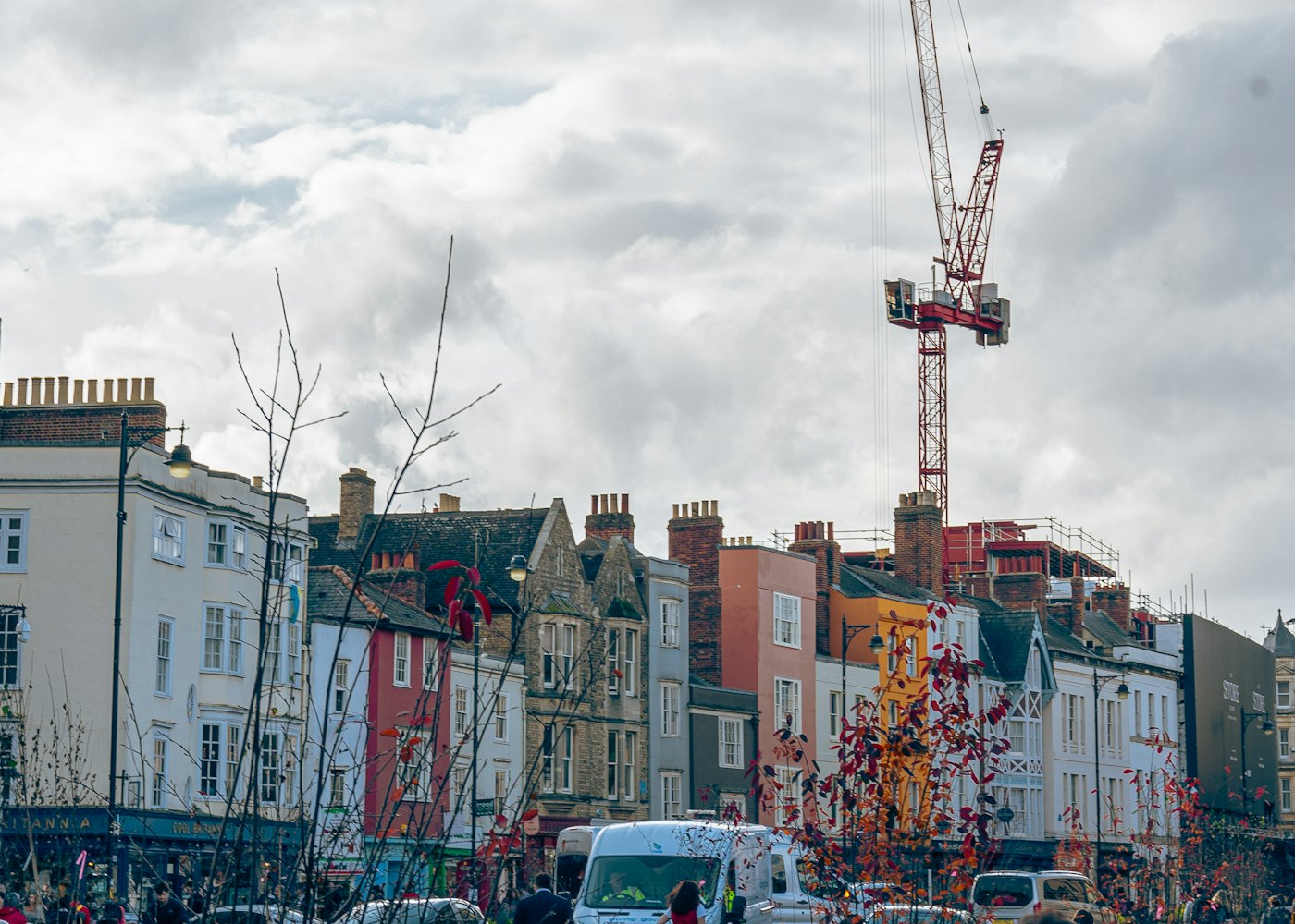Tower crane above a row of English town houses