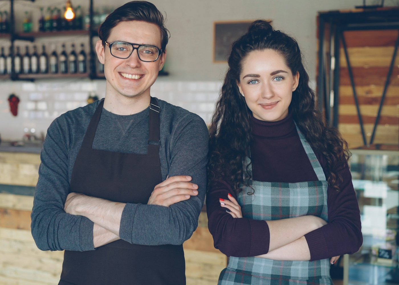Two cafe founders standing proudly in their new business