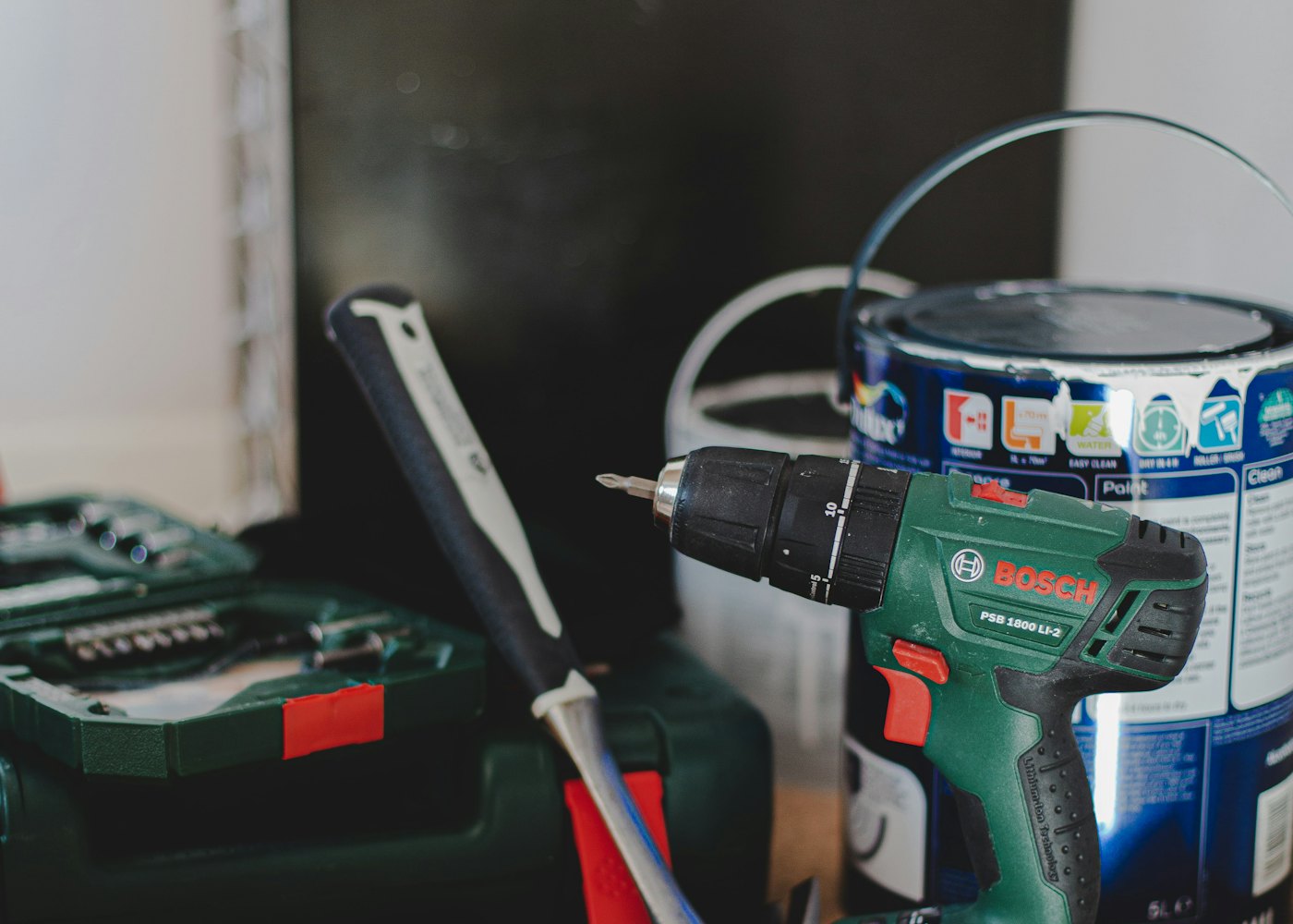 Cordless drill, tool case and paint tin